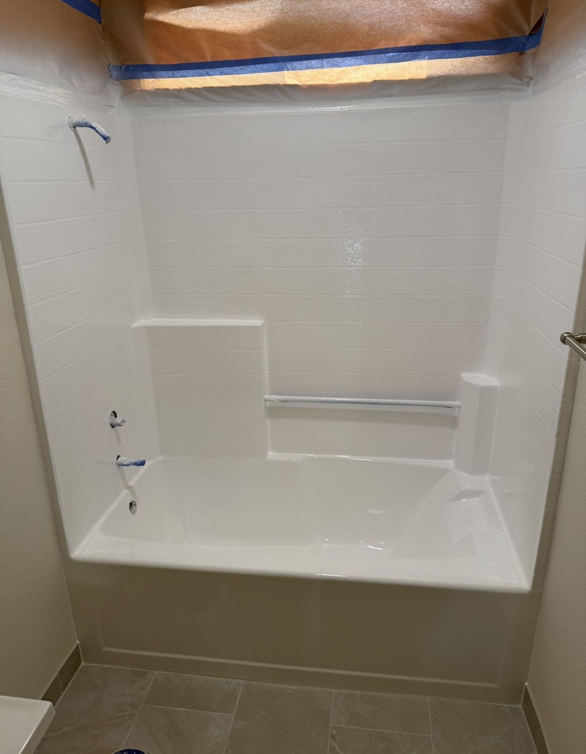 After: the same bathtub and tile reglazed to a fresh white finish