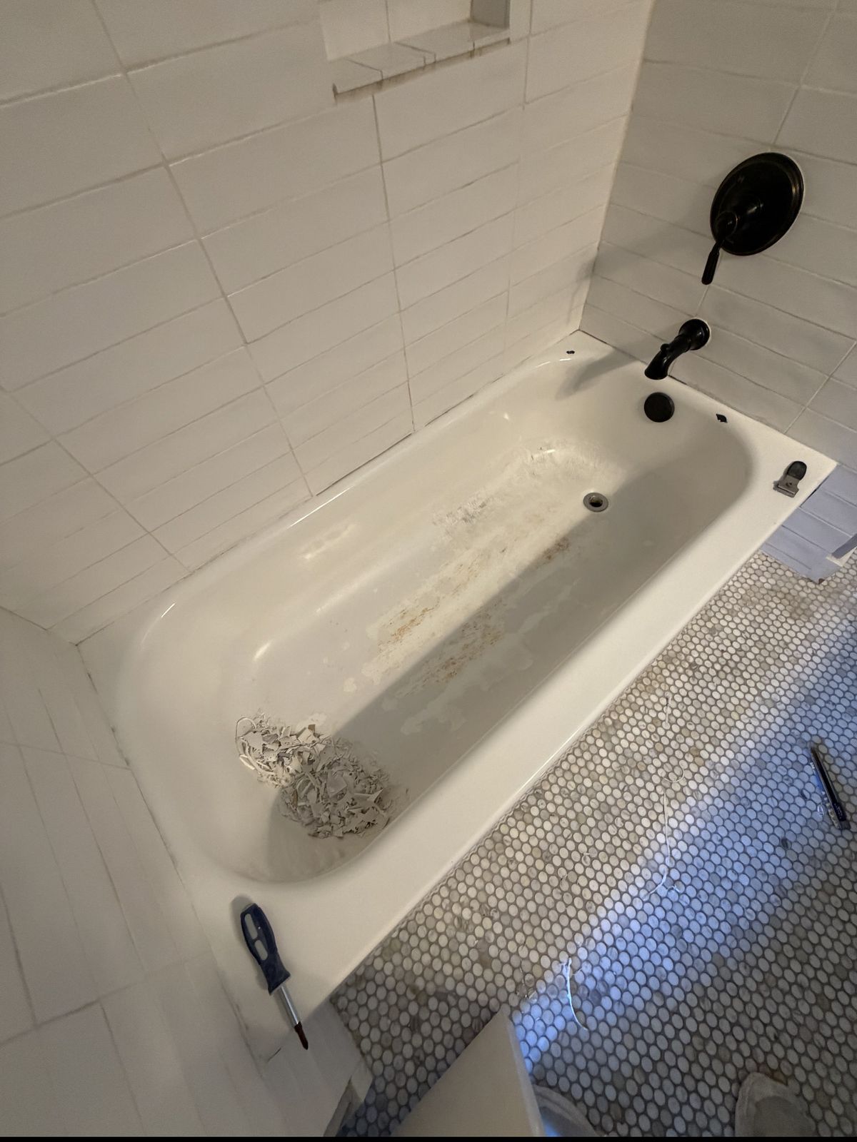 Stained, worn cast-iron bathtub before reglazing