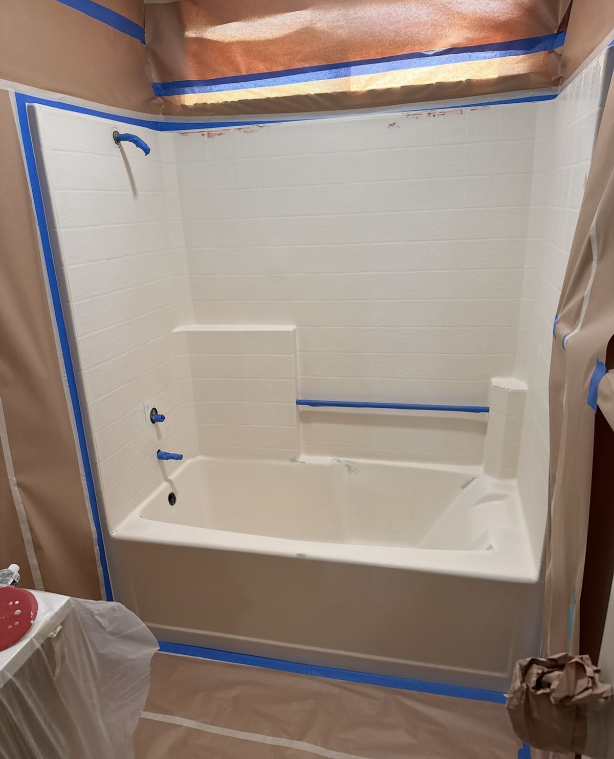 Before: a worn bathtub and tile surround